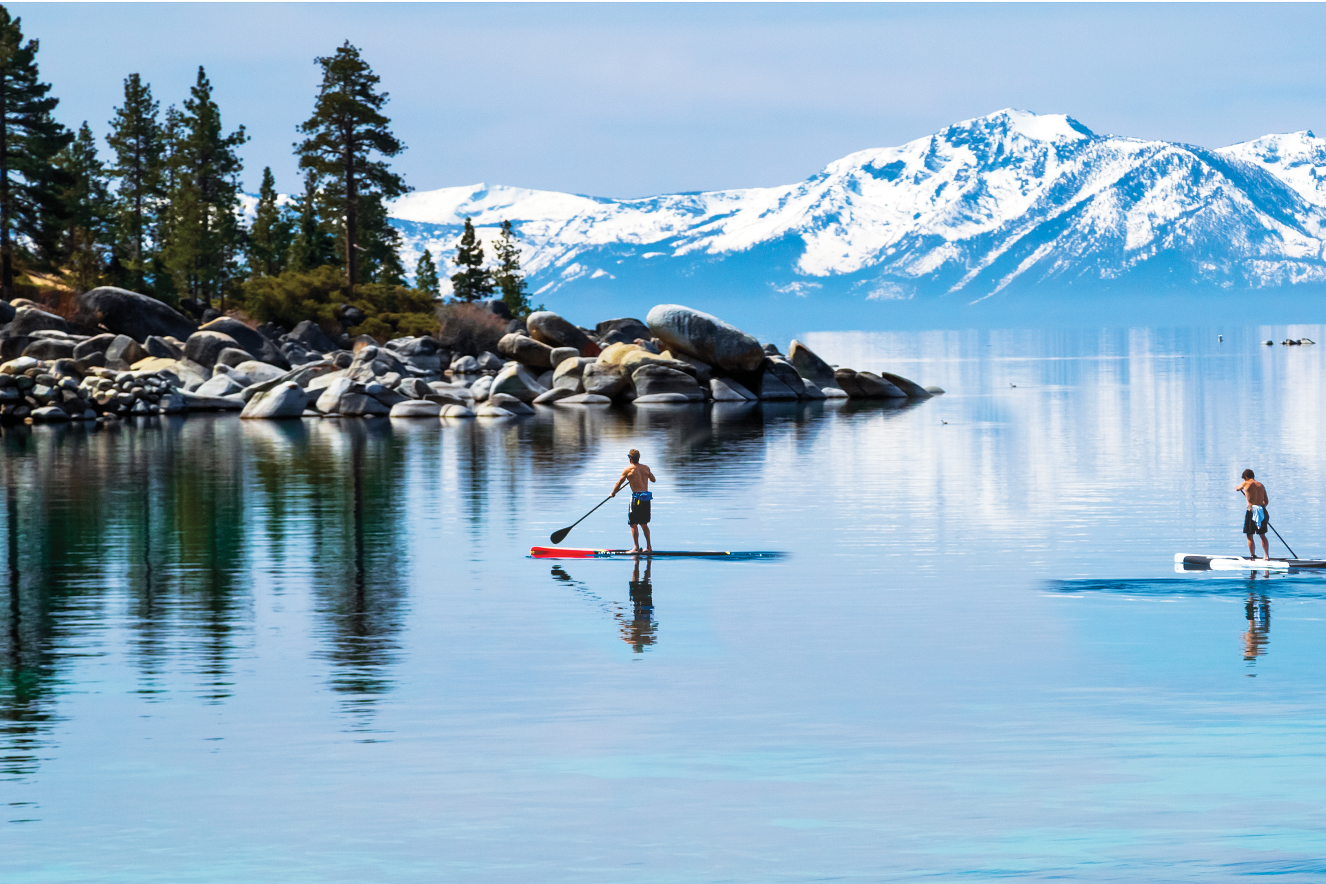 Scenic view of Lake Tahoe in November with vibrant fall colors and majestic snow-capped mountains