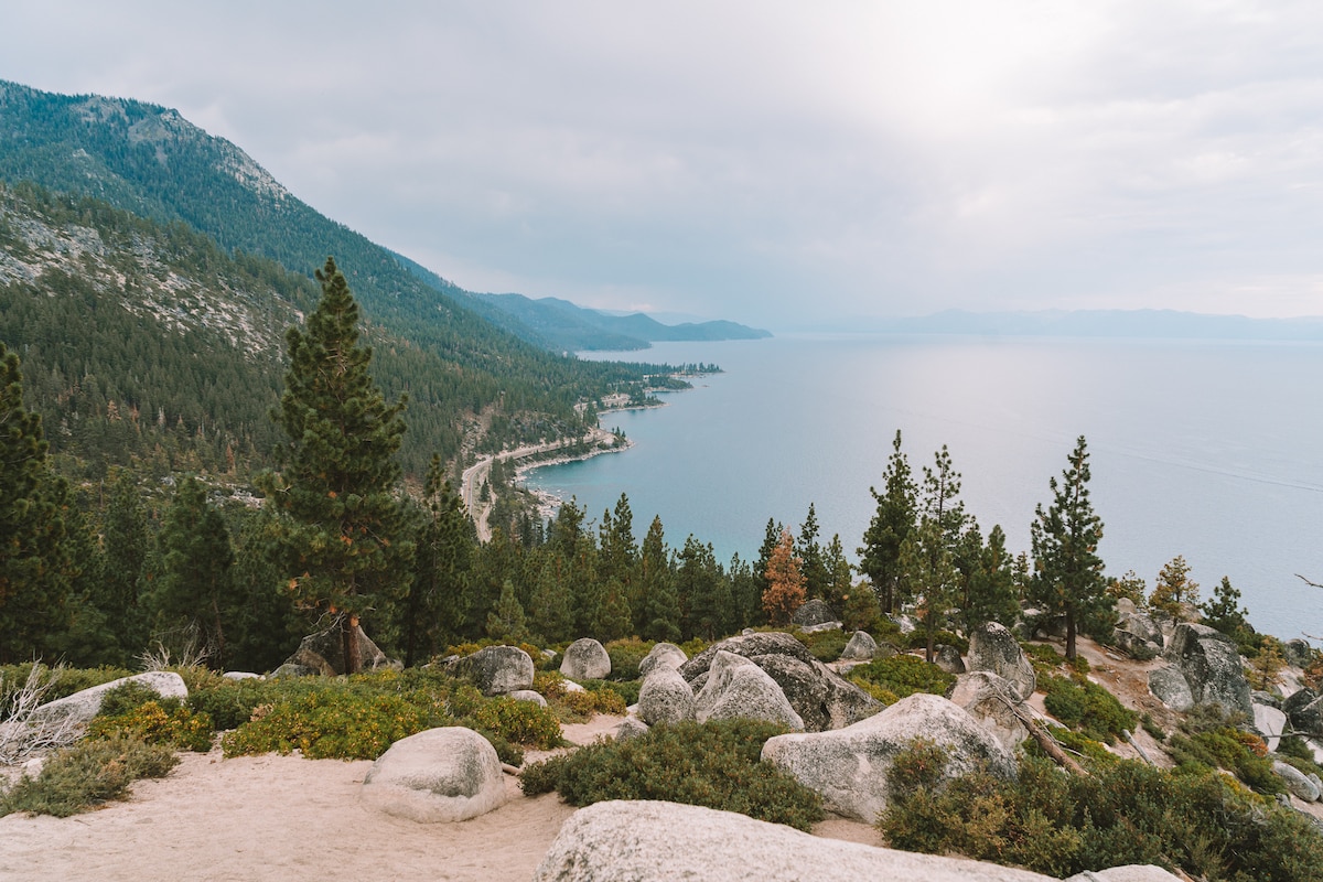 Panoramic view of Lake Tahoe\'s other side showcasing mountains, trails, and ski resorts